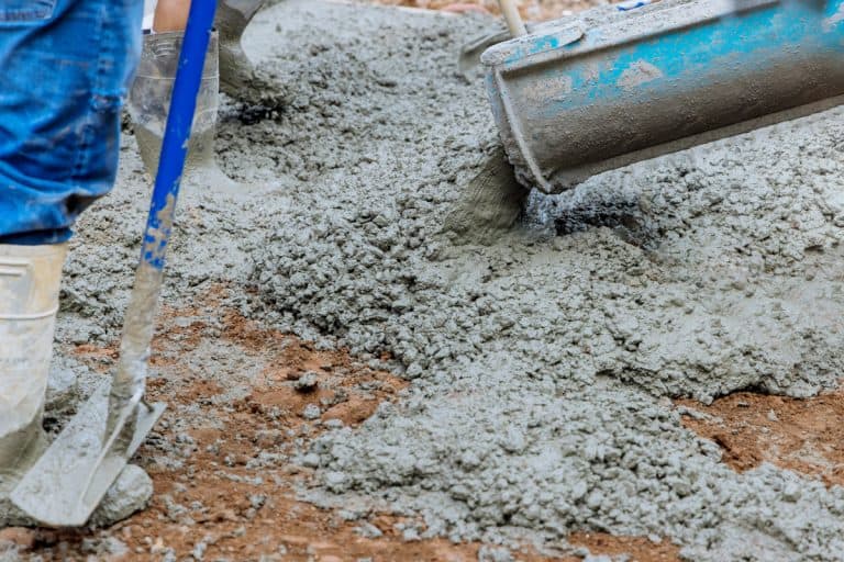 Worker evenly spreading concrete, Can You Pour Concrete Over Rubble?