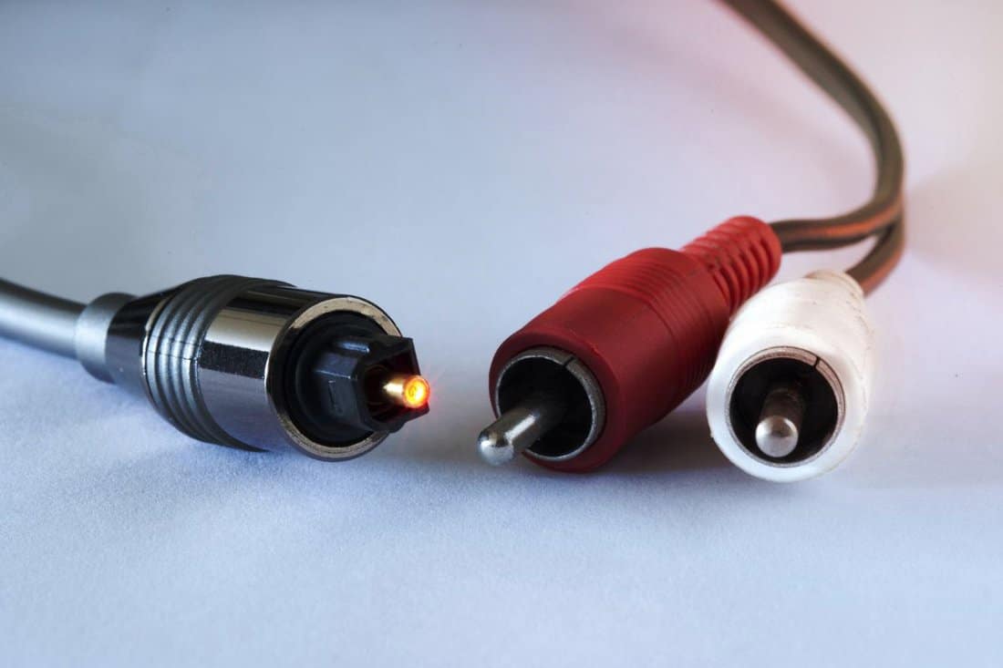 conceptual image of analog audio cables alongside a digital audio connection.