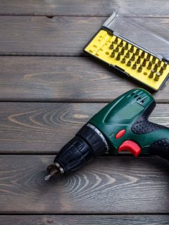 cordless screwdriver with different bits on brown wooden background. - Hog [Friction] Ring Vs Pin Detent Pros And Cons Which Is Best
