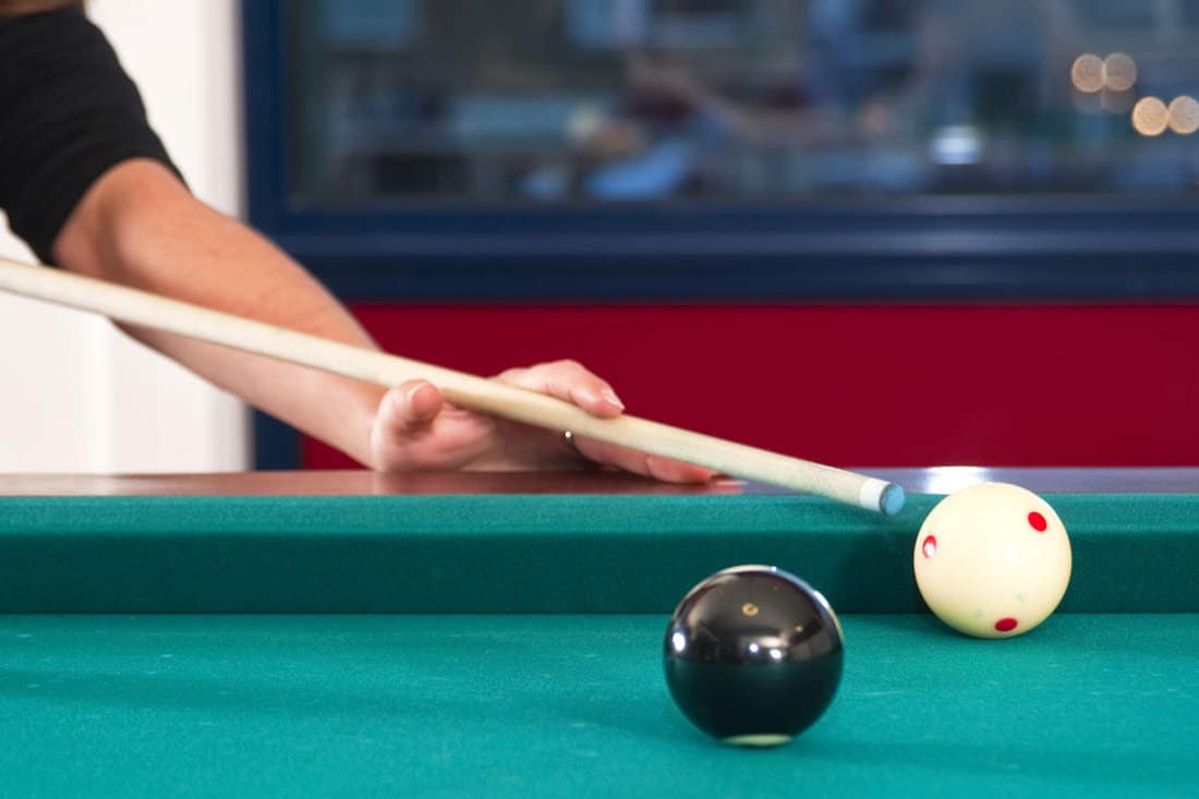 cue ball and cue stick during a game of pool