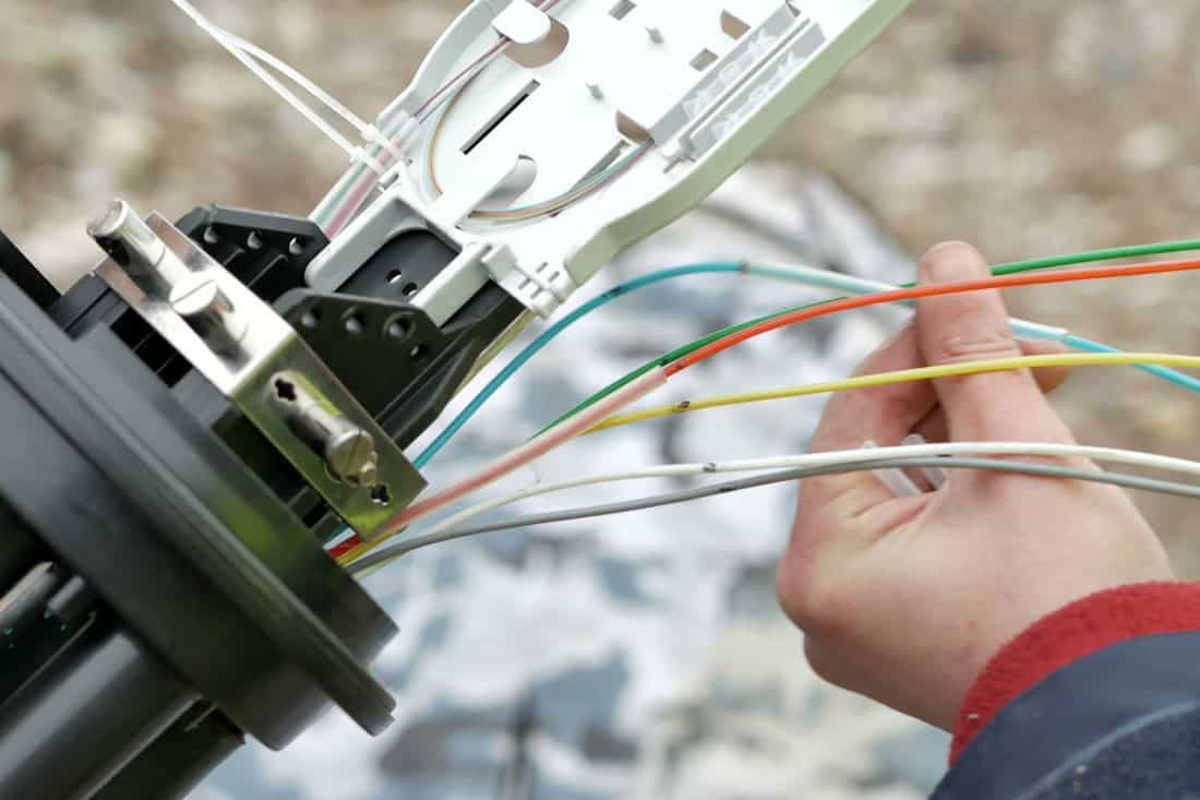 Technicians installing optic fiber cable ties