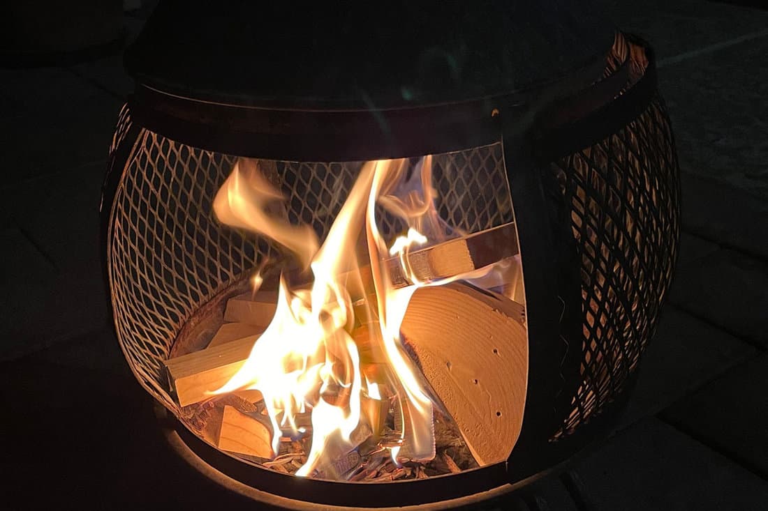 fire burns wood scraps patio chiminea