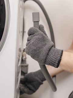 plumber repairing washing machine working man, Can The Washing Machine Drain Into A Sewage Pump?