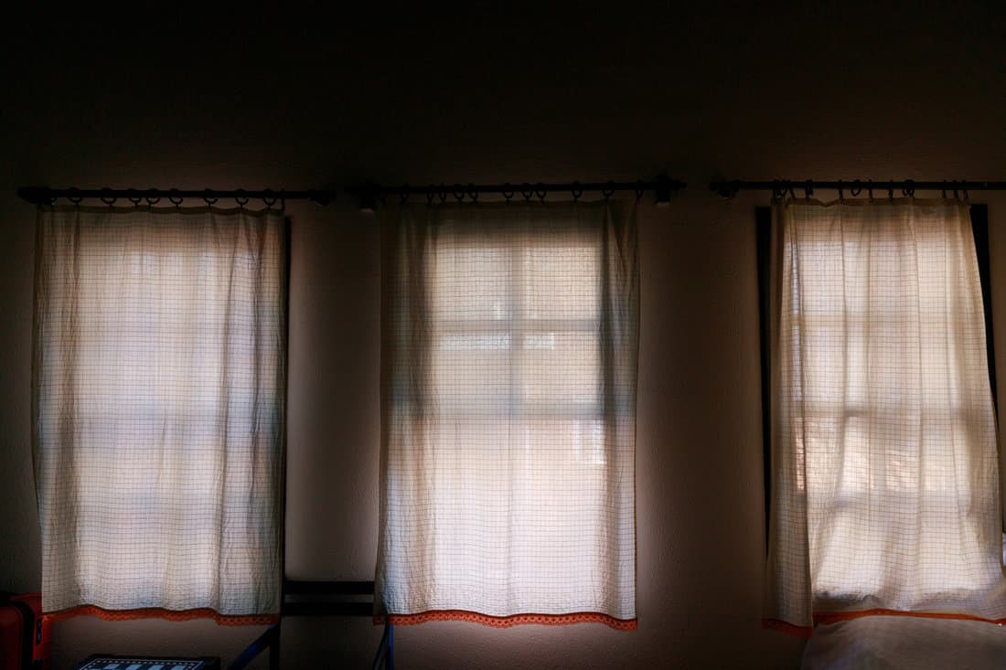 three curtained windows in an old hotel in Morocco. selective focus . High quality photo 