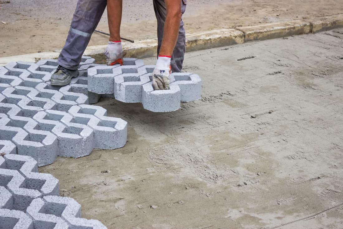 worker paving new parking places concrete