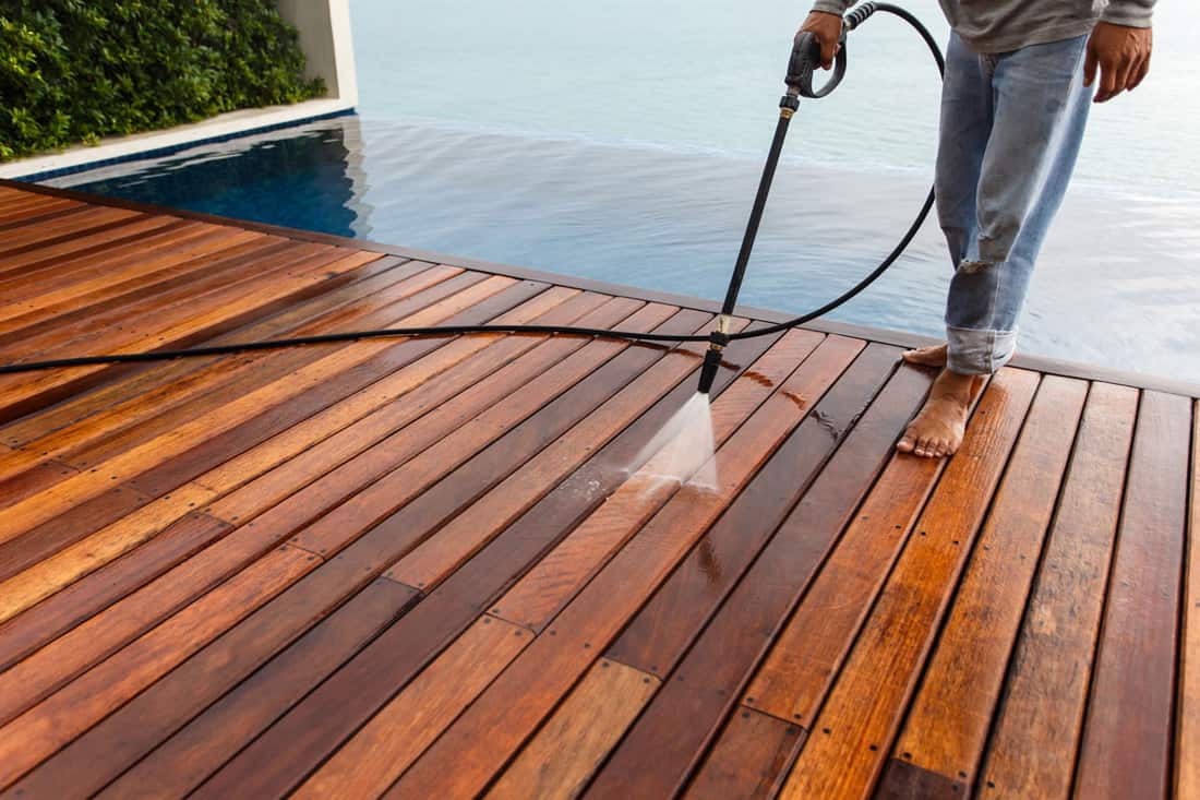 A doing a pressure wash on deck