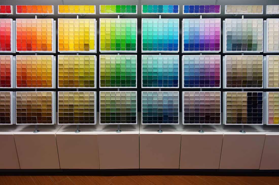 A shelf filled with different color codes provided by Sherwin Williams