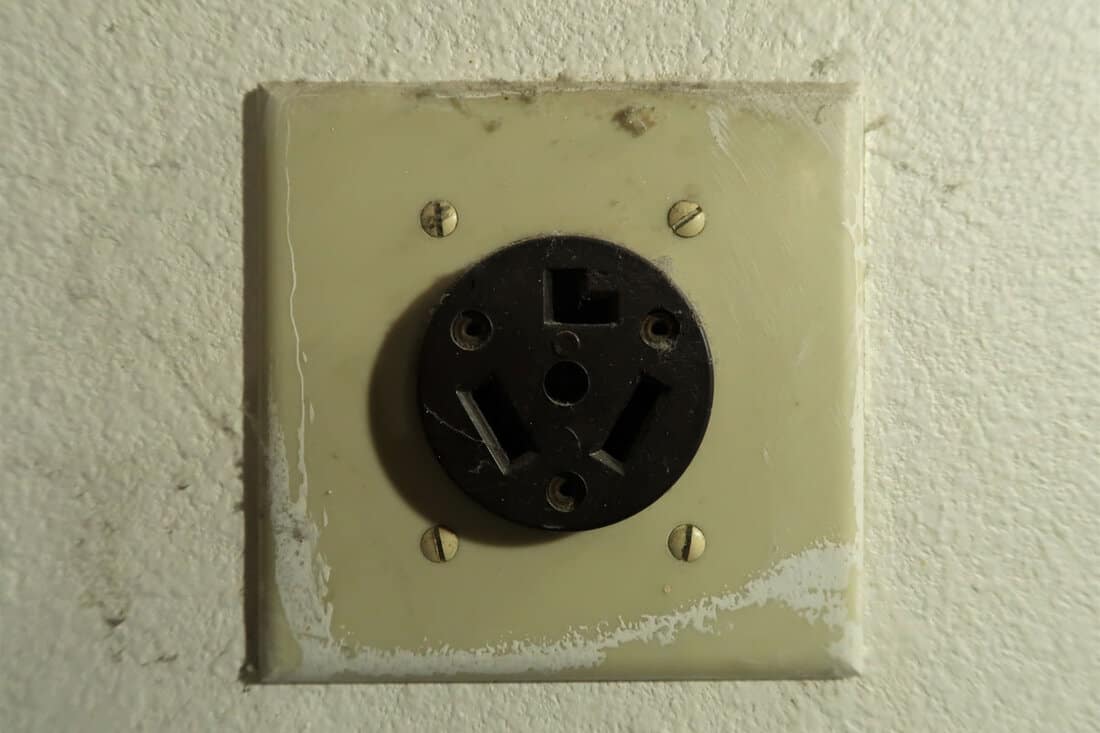 An old outlet for a dryer in a garage