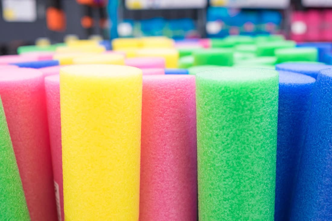 Close up view of colorful floating noodles. Plastic foam pool noodles. Background. 