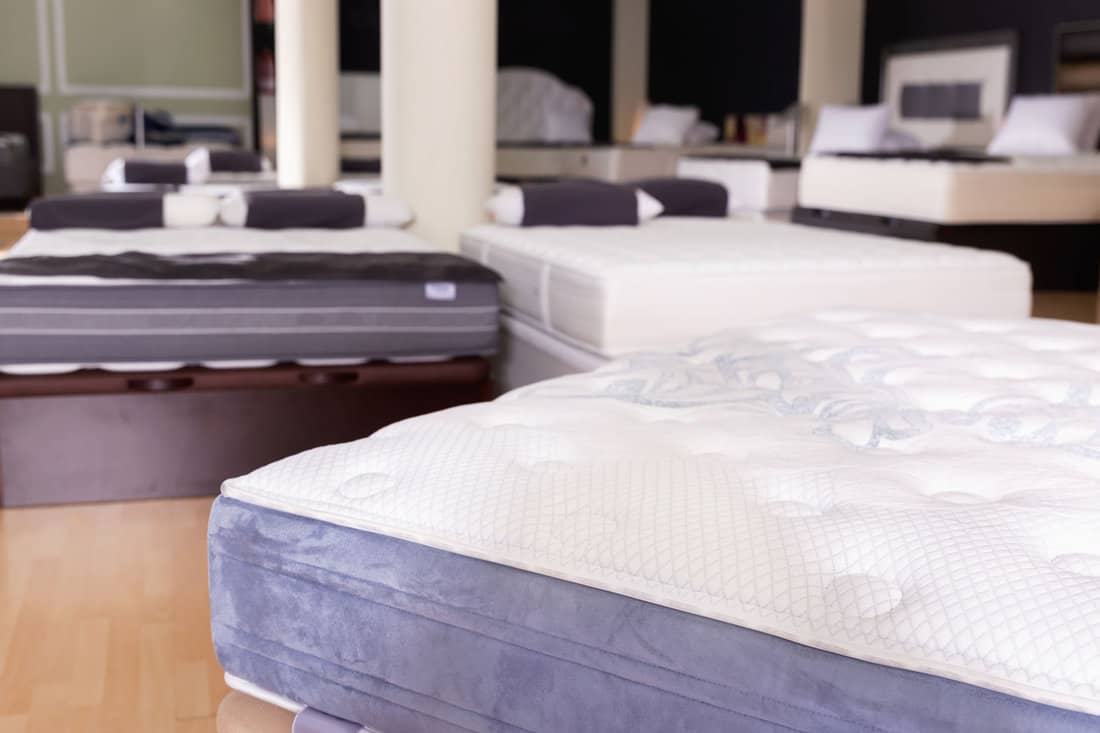 Closeup of new fashionable modern beautiful stylish orthopaedic mattress on display for sale in large furniture store 