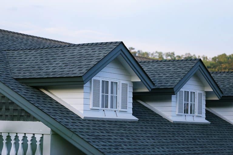 House garret with asphalt shingles in a blue sky, Pros And Cons Of Painting Asphalt Shingles