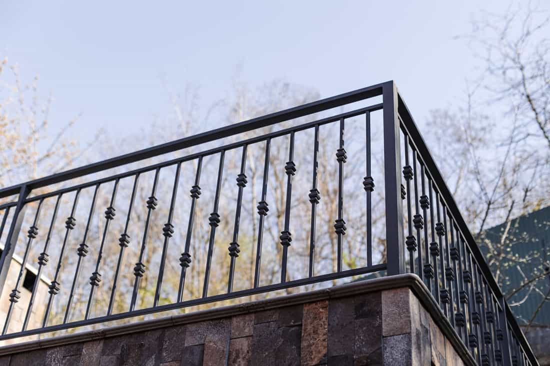 Modern metal railings and handrails in the loft style. The metal is treated with a primer and anti-corrosion paint. Interior design in industrial style. High quality photo 