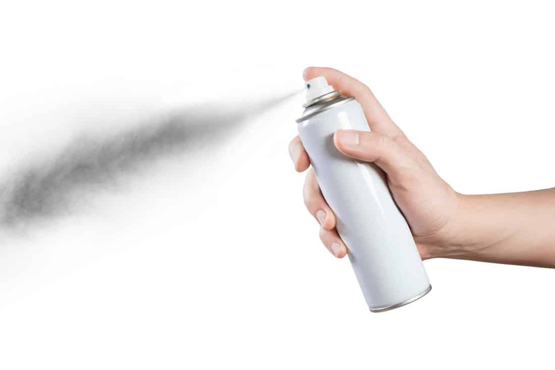 Man using an aerosol spray