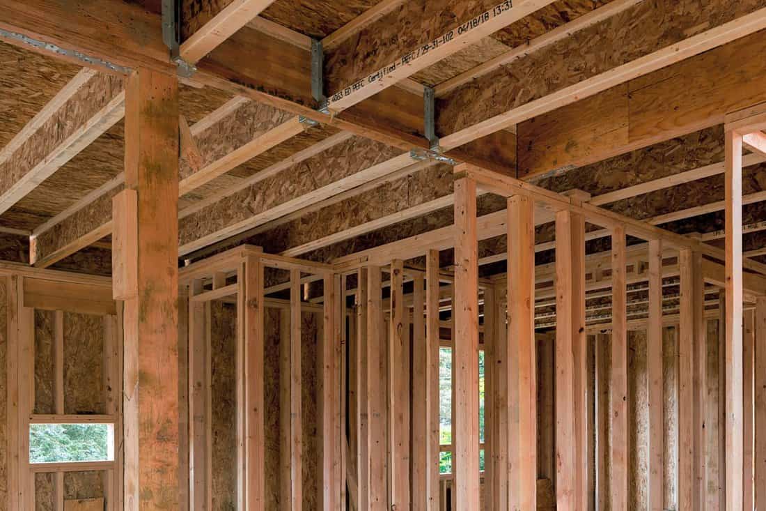 New home construction interior wood stud framing ceiling beams and stair