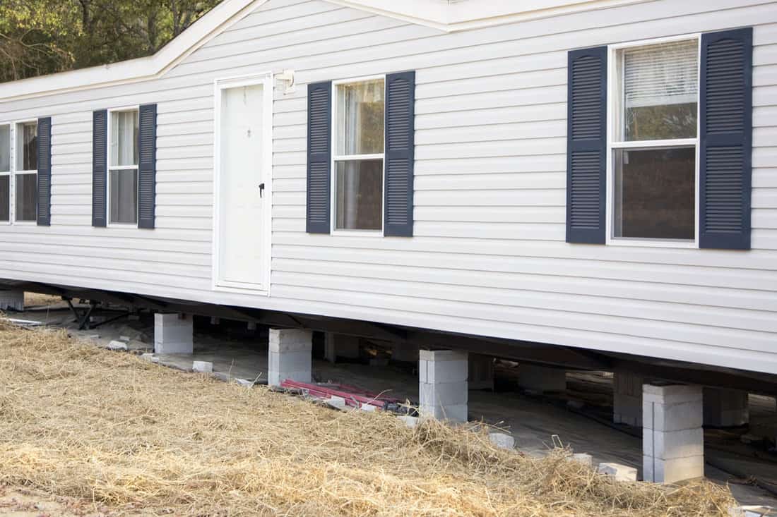 New mobile home is being installed on its cement block foundation