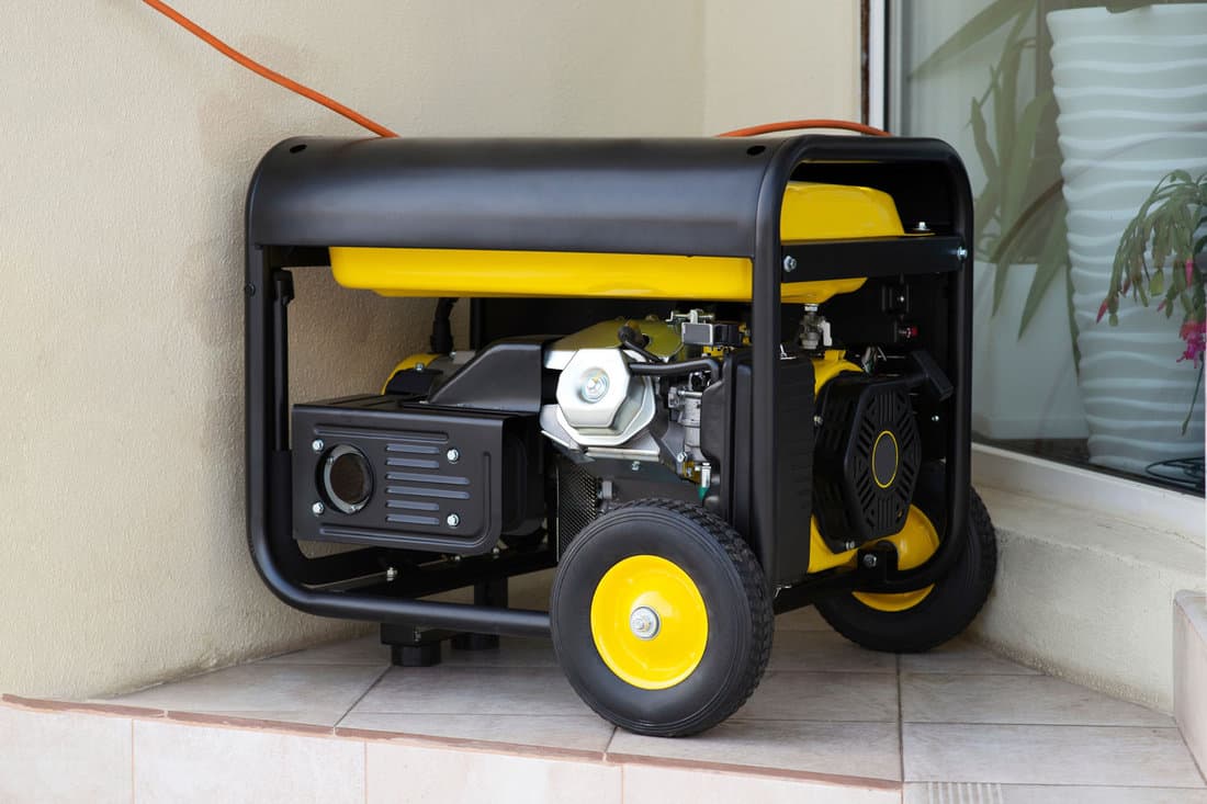 Portable electric generator running in the cold winter.Energy genocide. Power outage as a result of missile strikes by Russia on energy facilities of Ukraine. Small business use gasoline generators 