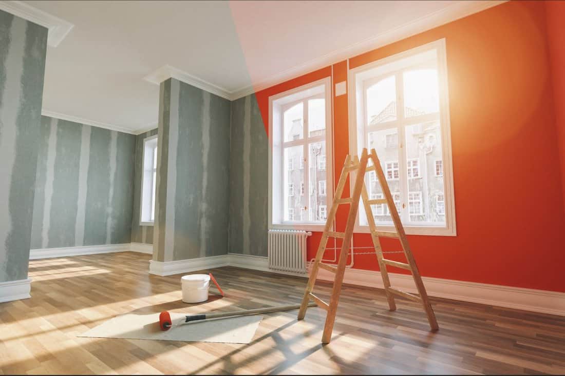Painting wall red in room before and after restoration or refurbishment.