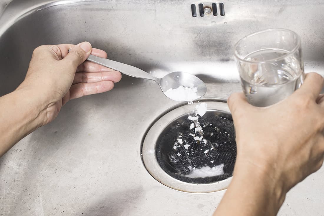 Pour a spoon of baking soda and a glass of vinegar respectively into the drain of sink