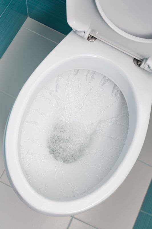 clean water flowing into a white toilet