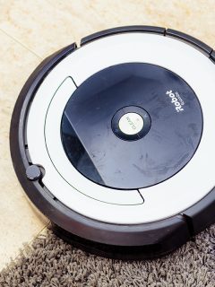 iRobot vacuum cleaner Roomba cleaning a gray carpet, Can You Reuse iRobot Bags?