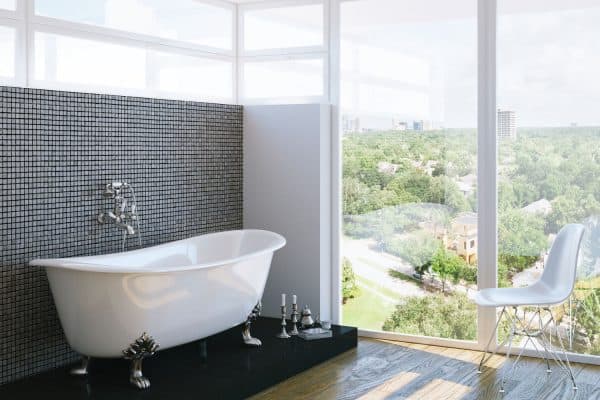 modern bathroom in bright interior with big window, Garden Tub Vs Roman Tub What's The Difference