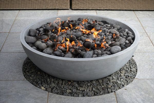 modern fire pit on backyard patio, Can Limestone Be Used For A Fire Pit?