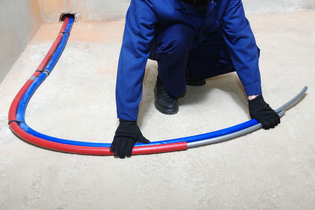 plumber installing plastic pipes doing maintenance