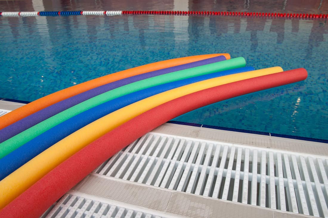 water aerobic equipment. colored aqua noodles in swimming pool 