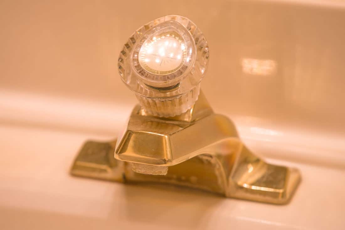 yellow lit faucet sink golden color
