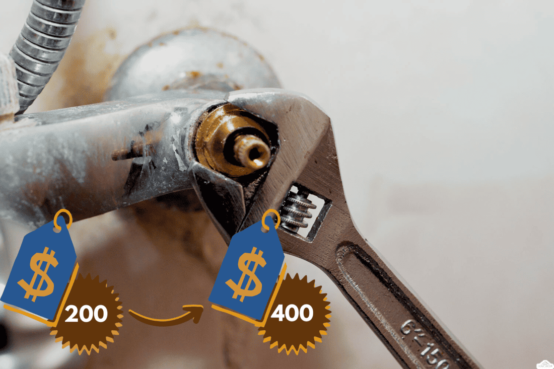 A plumber fixing a problem of a shower faucet tap spinning the cartridge body with an adjustable wrench tool to change it, plumbing and maintenance concept background at home, selective focus, Can You Lubricate A Moen Shower Cartridge [Yes! Here's How!] 3