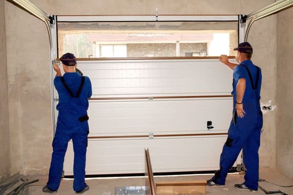 Contractors installing garage door, How To Install A Garage Door In A Cinder Block Wall