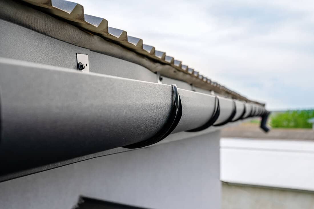 Gutter system for a metal roof. Holder gutter drainage system on the roof
