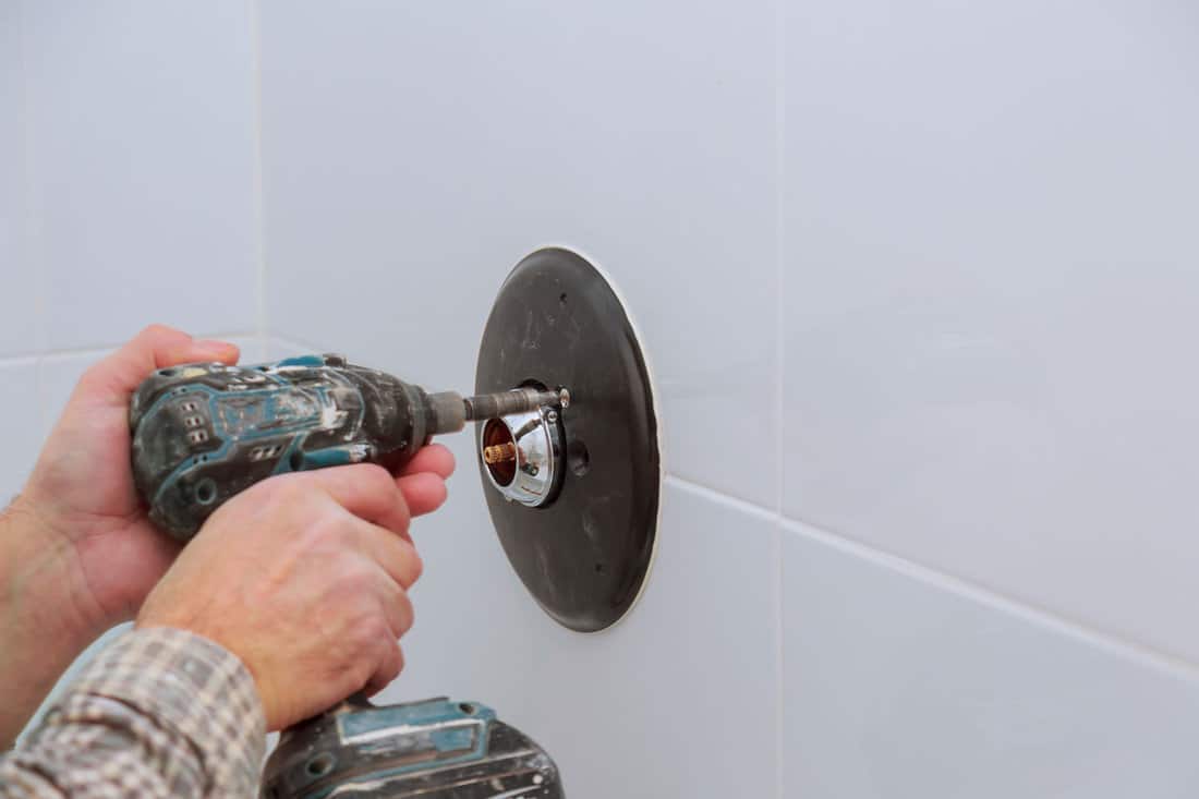 Installing a new on shower mixer tap in a bathroom 