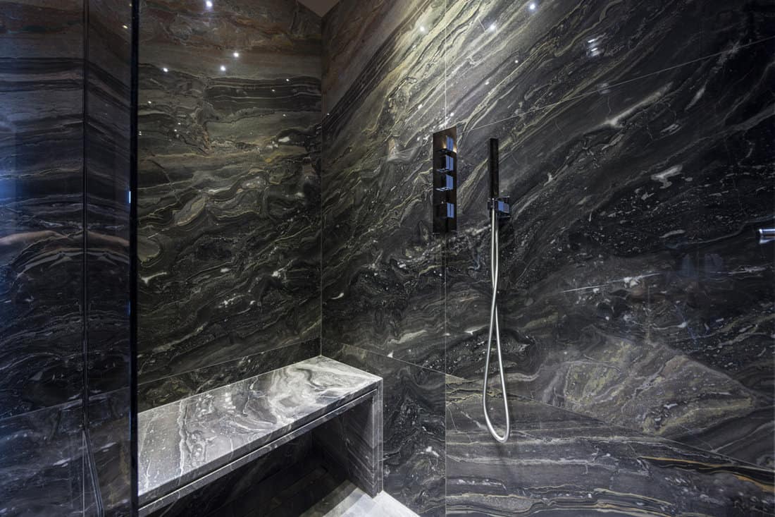 Interior of modern bathroom with black marble 