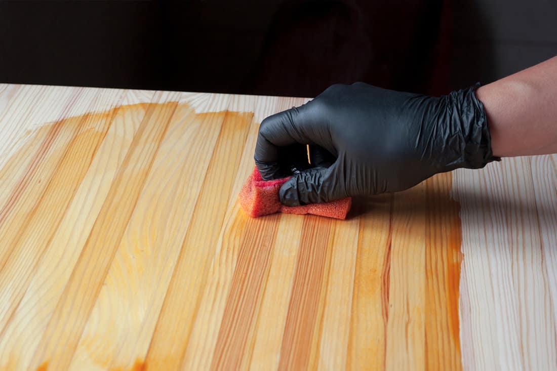 Treatment of a wooden surface for protection against aging