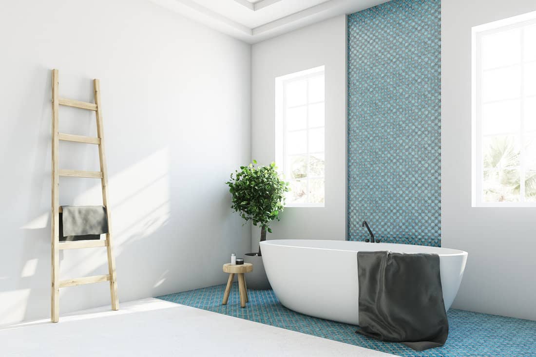 White and blue bathroom interior with a round white tub