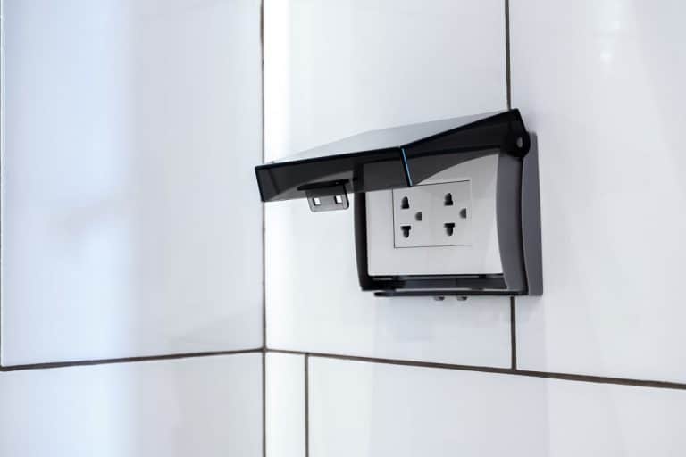 hite electrical plug socket plate panel with transparent plastic shield on tiles in bathroom wall, Do I Need A Fused Spur For A Bathroom Mirror?