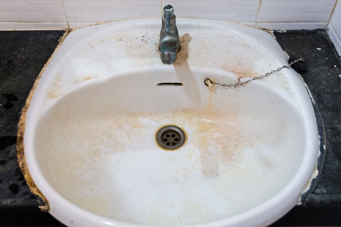 old dirty washbasin rust stains limescale