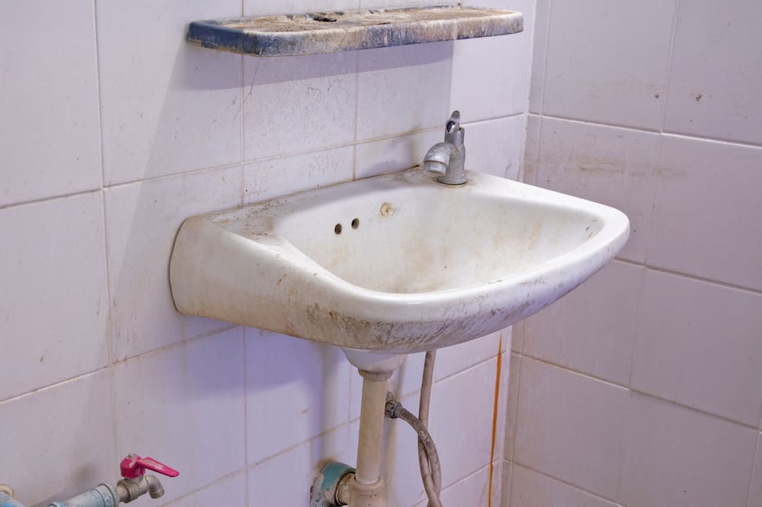 old dirty white ceramic wash basin