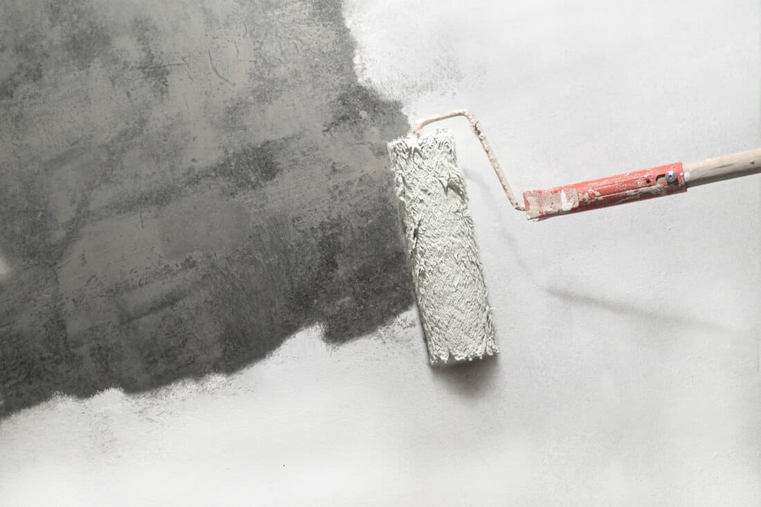 unpainted part concrete with paint roller on move