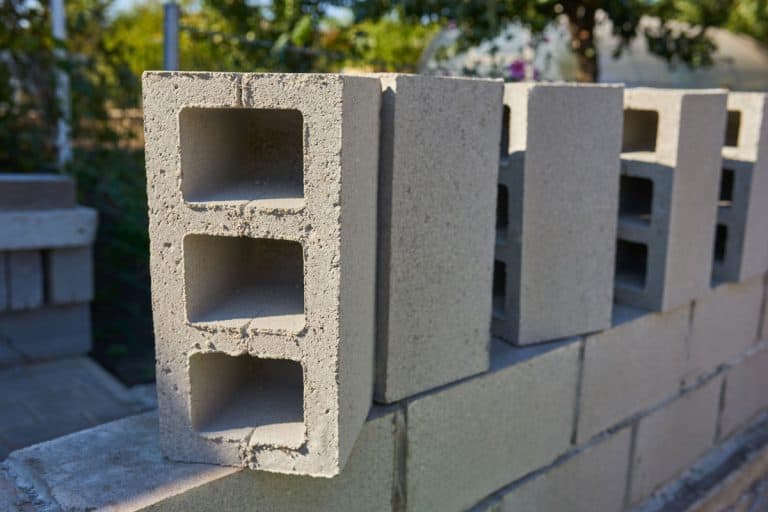worker builds cinder block wall new house building, Can You Use Tapcons In Cinder Block?
