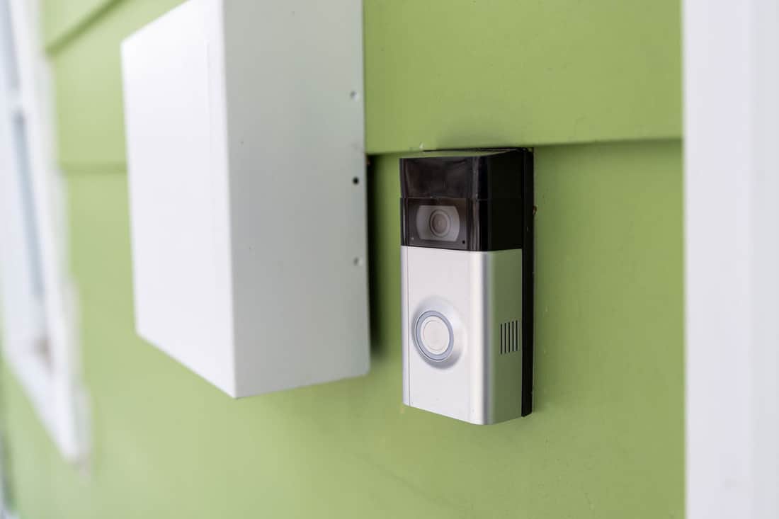 A modern doorbell installed outside the front door