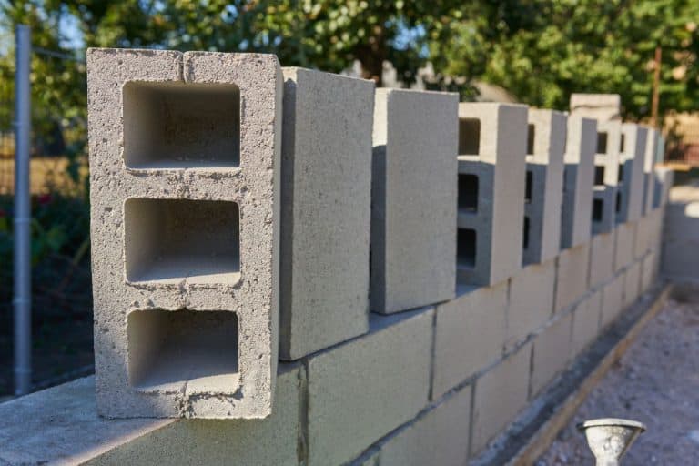 Stack of cement blocks at the construction site. cinder blocks background. - Haydite Block Vs. Cinder Block Pros, Cons, & Differences
