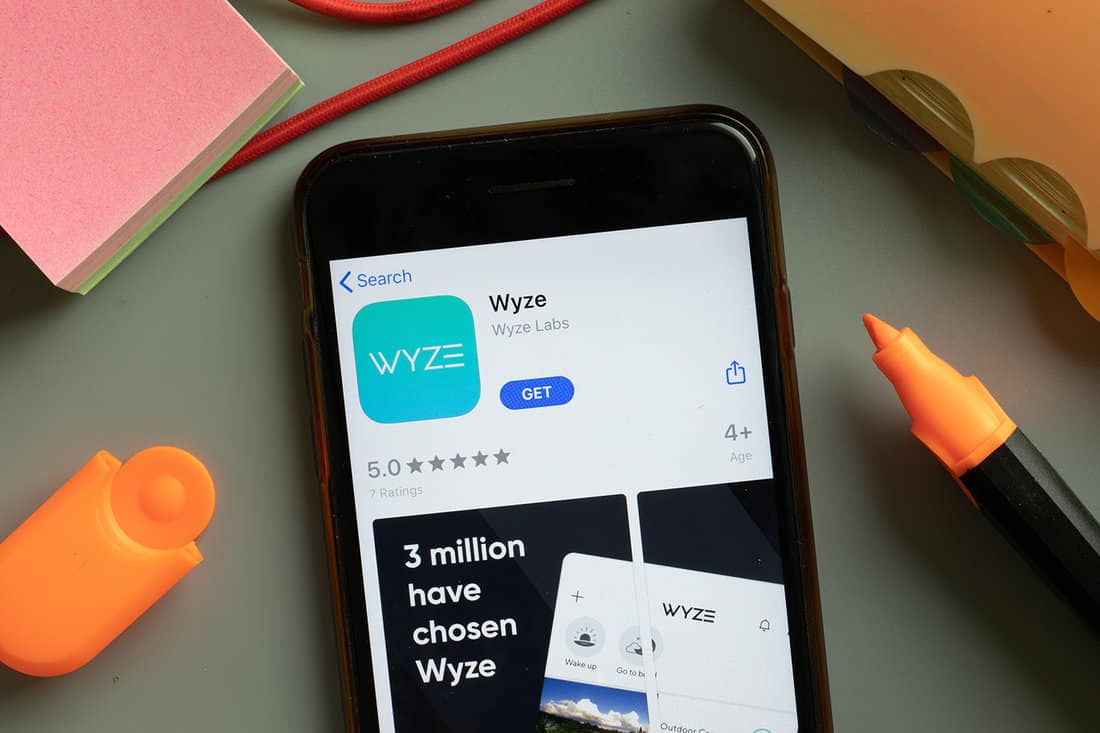 Wyze mobile app logo on phone screen close up