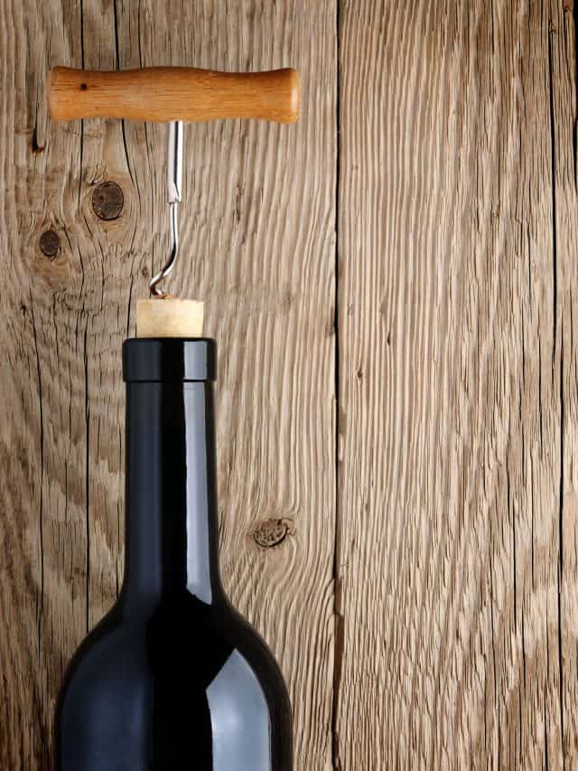 bottle of wine with cork, cork screw on top