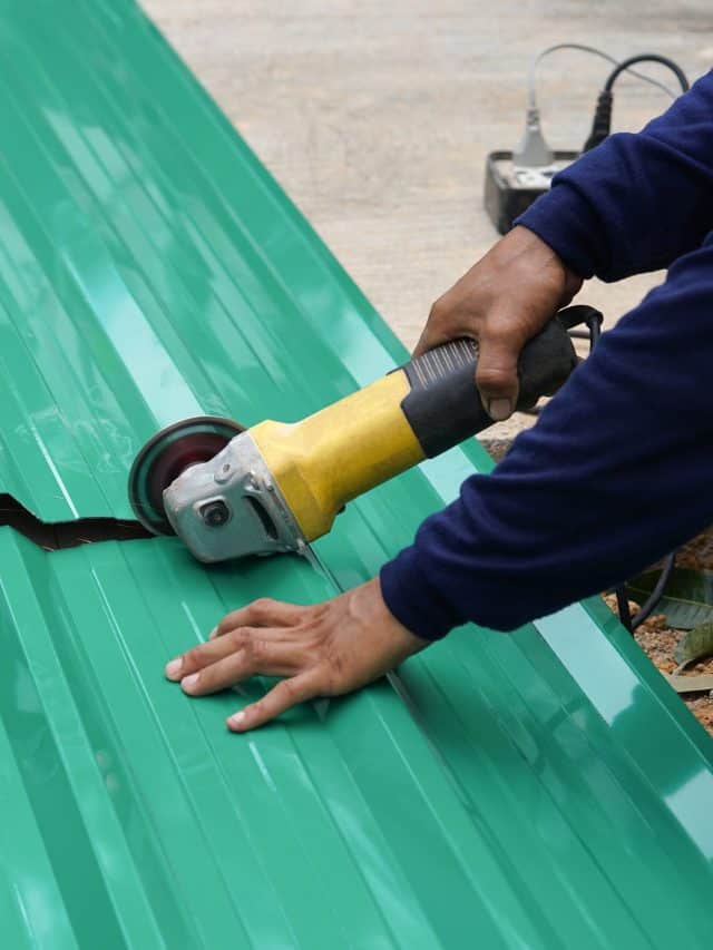 Worker hands cutting a metal sheet
