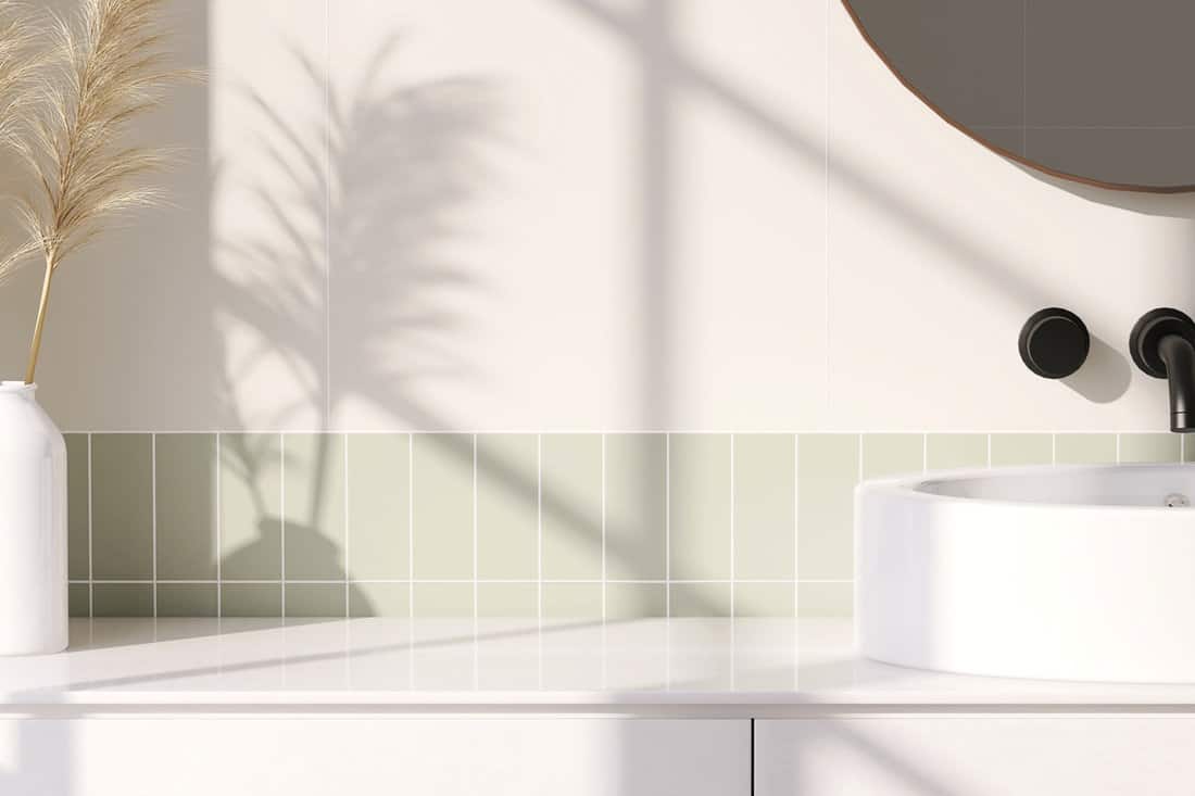 3D render an empty white vanity counter with ceramic washbasin and modern style faucet in a bathroom with morning sunlight and shadow