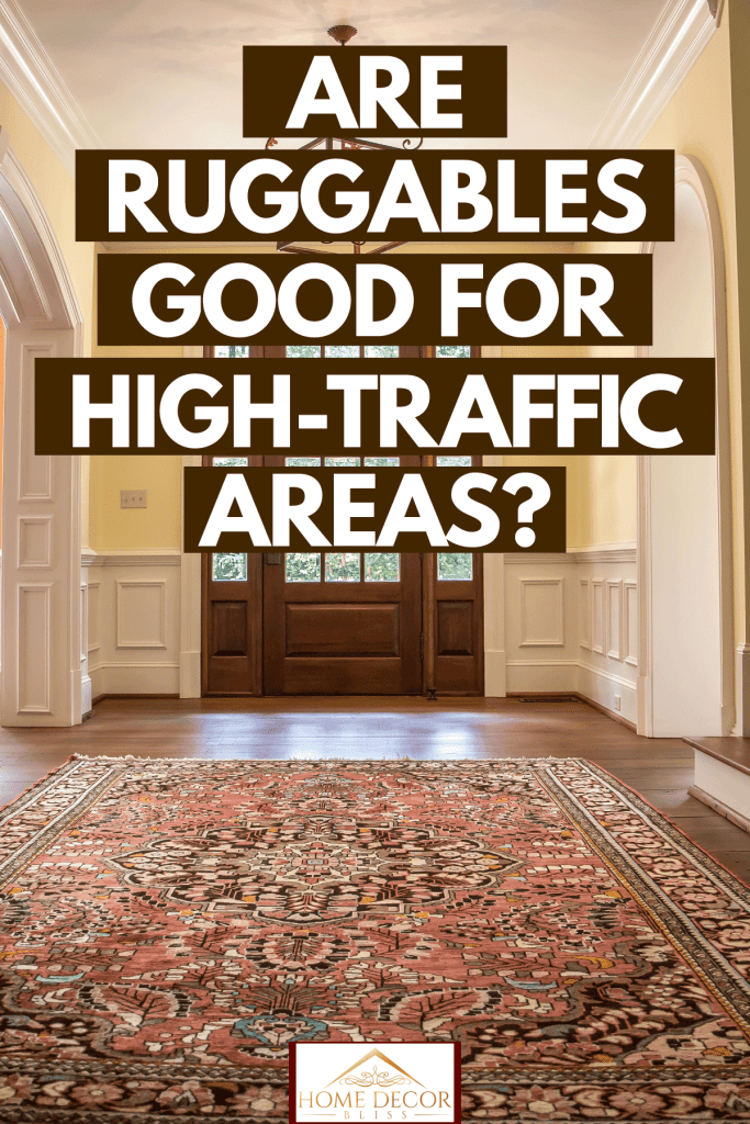Classic American themed living room with beige walls, white trims and wooden flooring with a huge wooden front door, Are Ruggables Good for High-Traffic Areas?