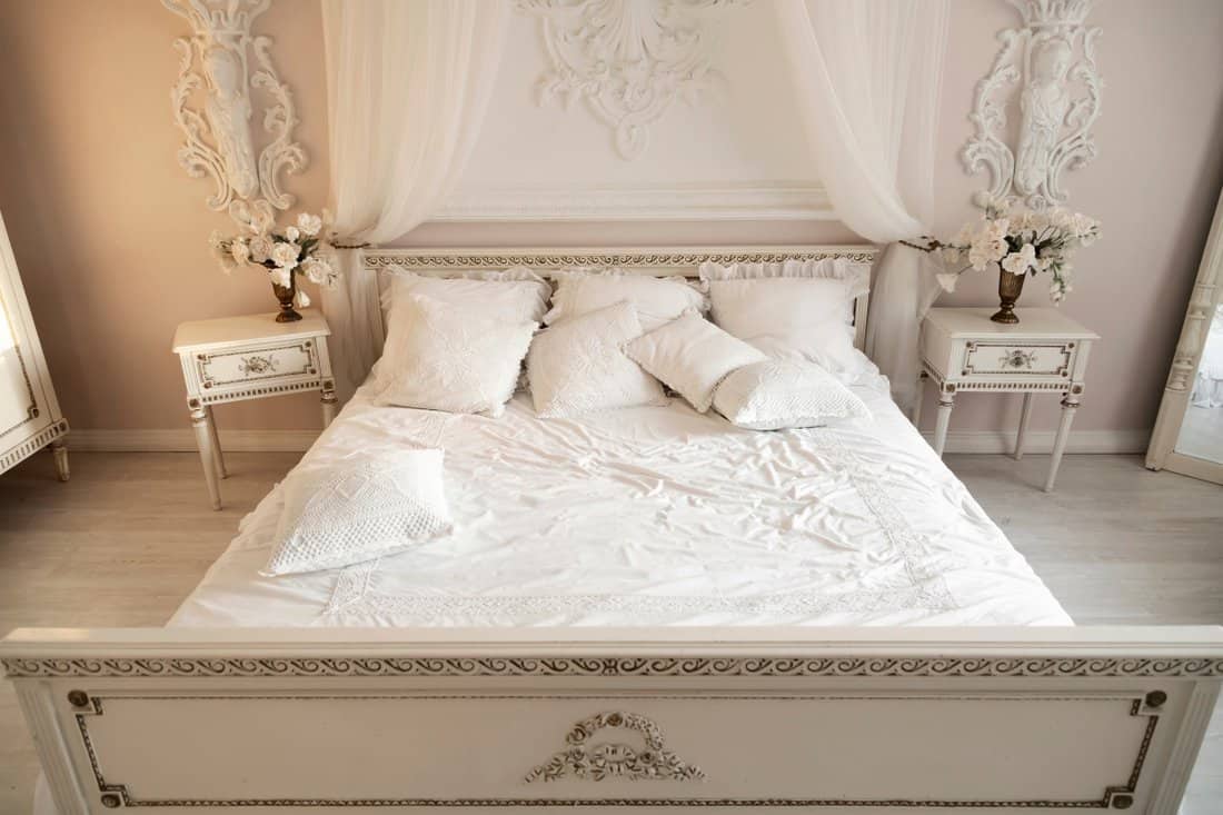 Bedroom in soft light colors. A large comfortable double bed in an elegant classic interior. A luxurious interior in the ancient antique style., The World’s Biggest Bed