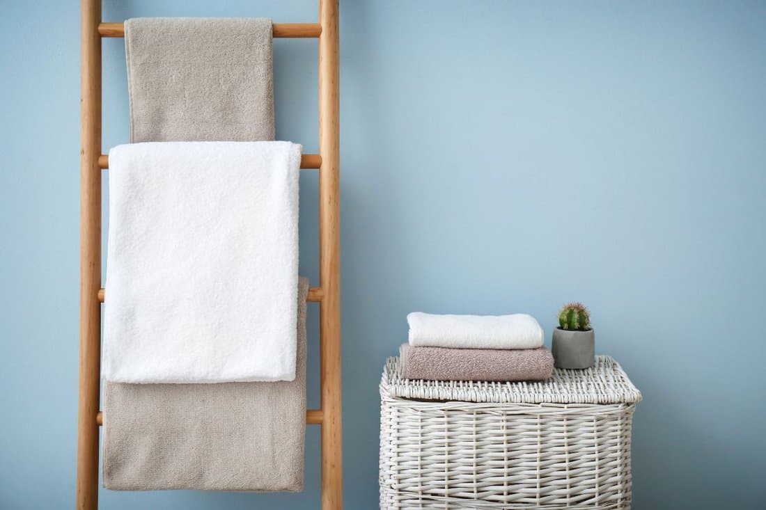 Clean towels on holder and wicker basket in bathroom